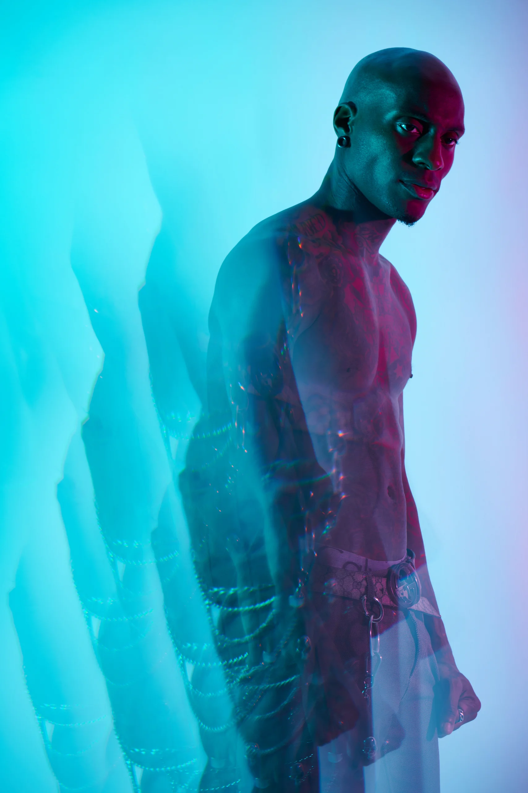A figure turned toward the camera, repeated in a trail of cyan silhouettes.