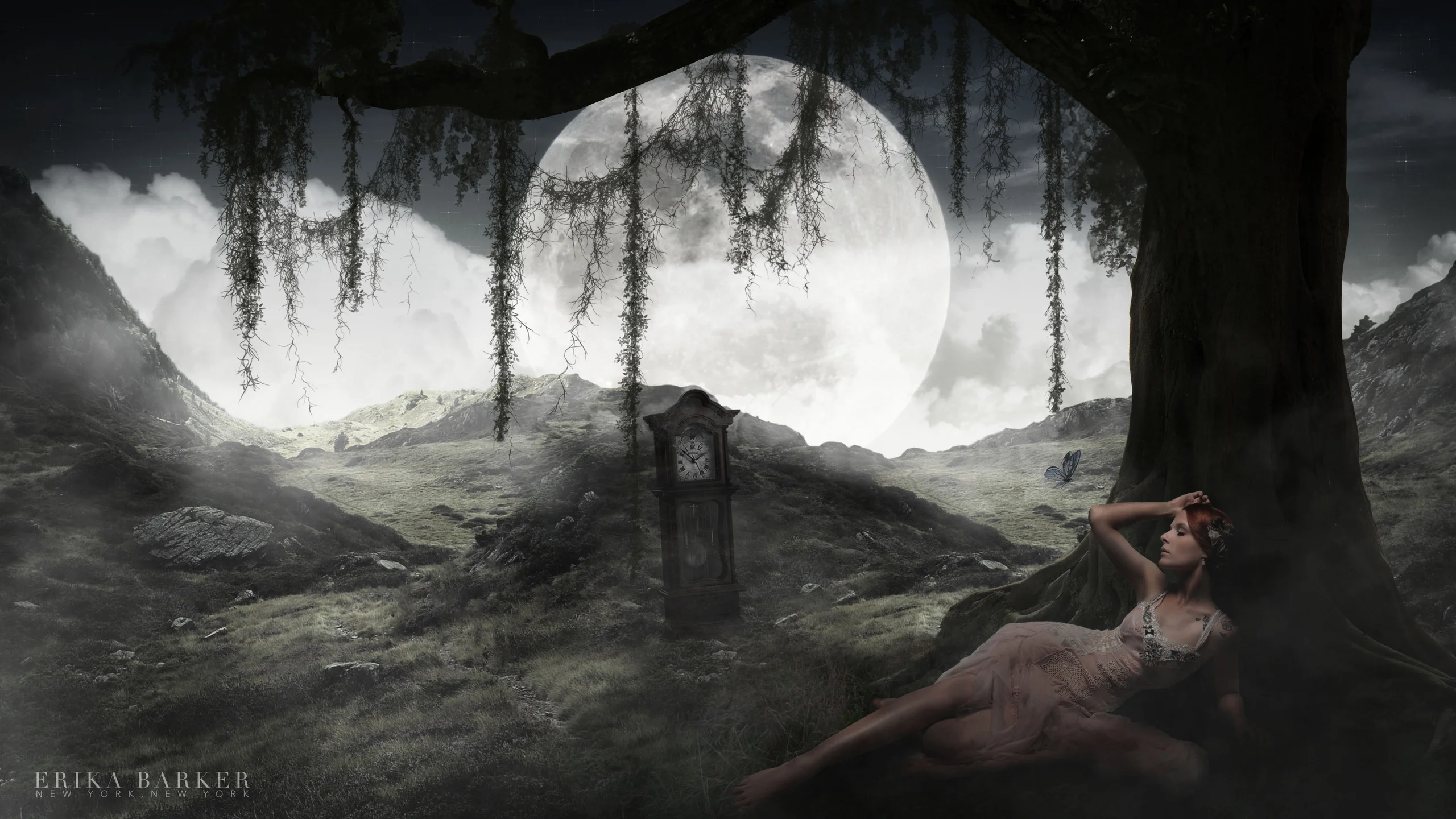 A photographic composite of a reclining woman beneath a tree, with an oversized moon and a telephone box.