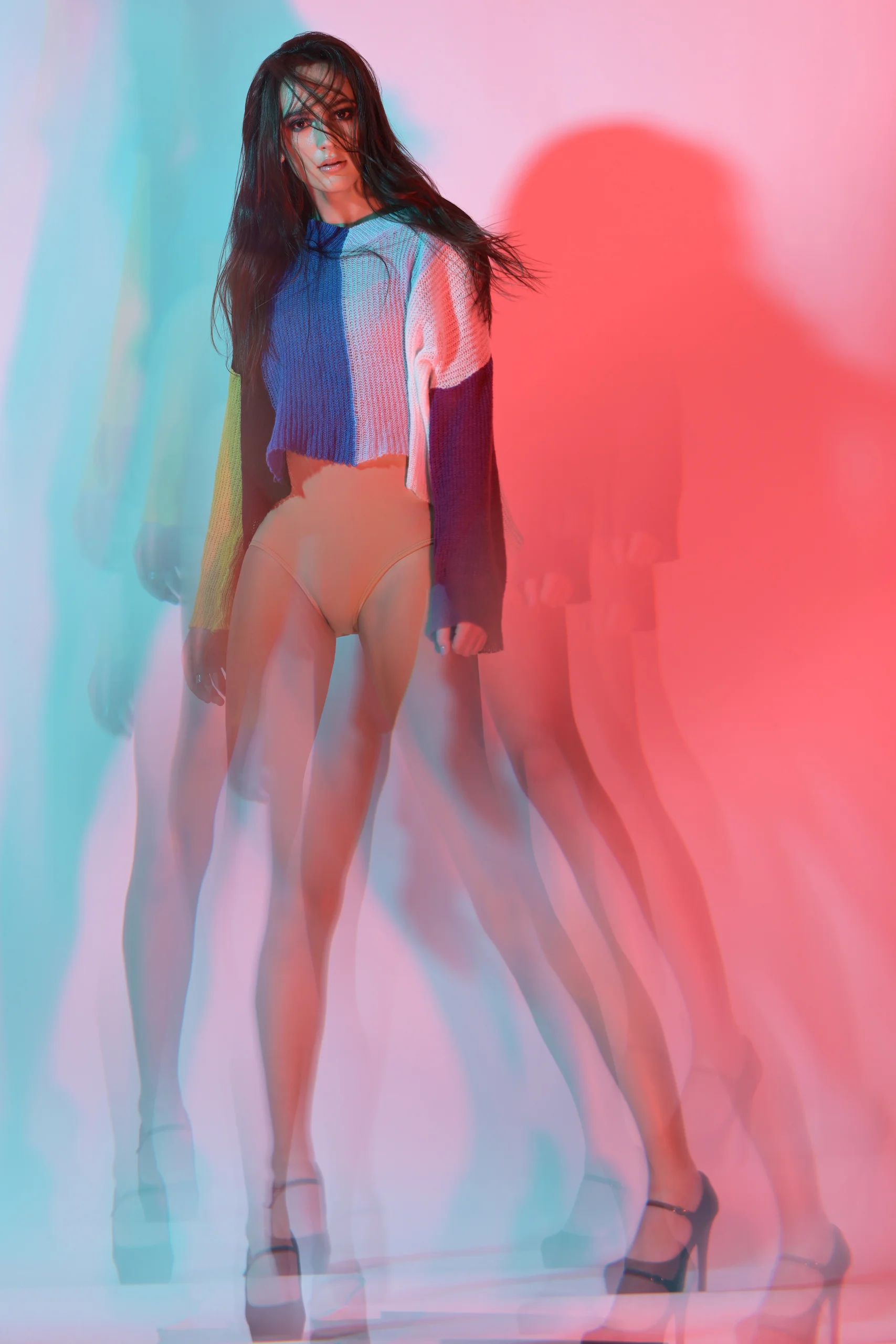 A layered full-length fashion image with overlapping red and blue silhouettes.