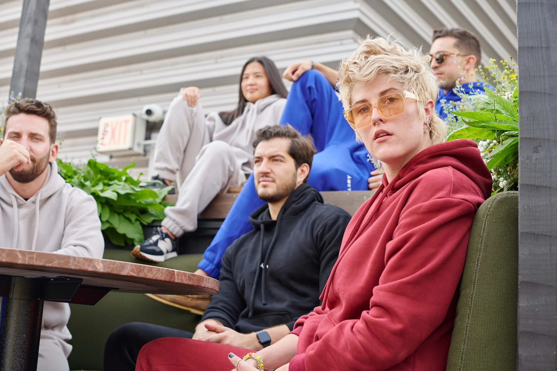 Models in ÁWET leisurewear gathered on outdoor steps.